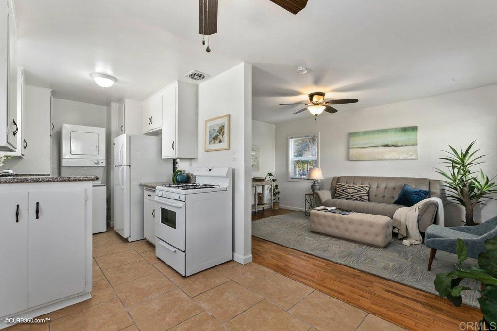 1453-1455 Thomas Avenue San Diego, CA 92109 - Photo 32 of 37 a living room with furniture and a chandelier