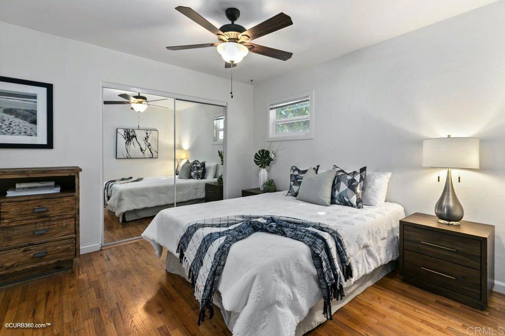 1453-1455 Thomas Avenue San Diego, CA 92109 - Photo 33 of 37 a bedroom with bed and a chandelier