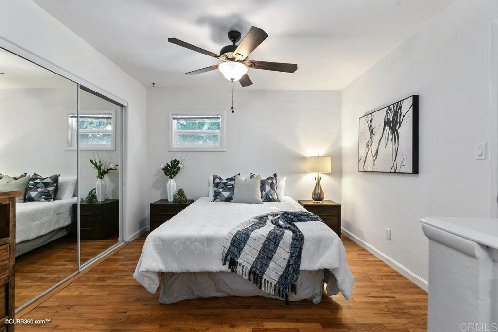 1453-1455 Thomas Avenue San Diego, CA 92109 - Photo 34 of 37 a bedroom with a bed and wooden floor