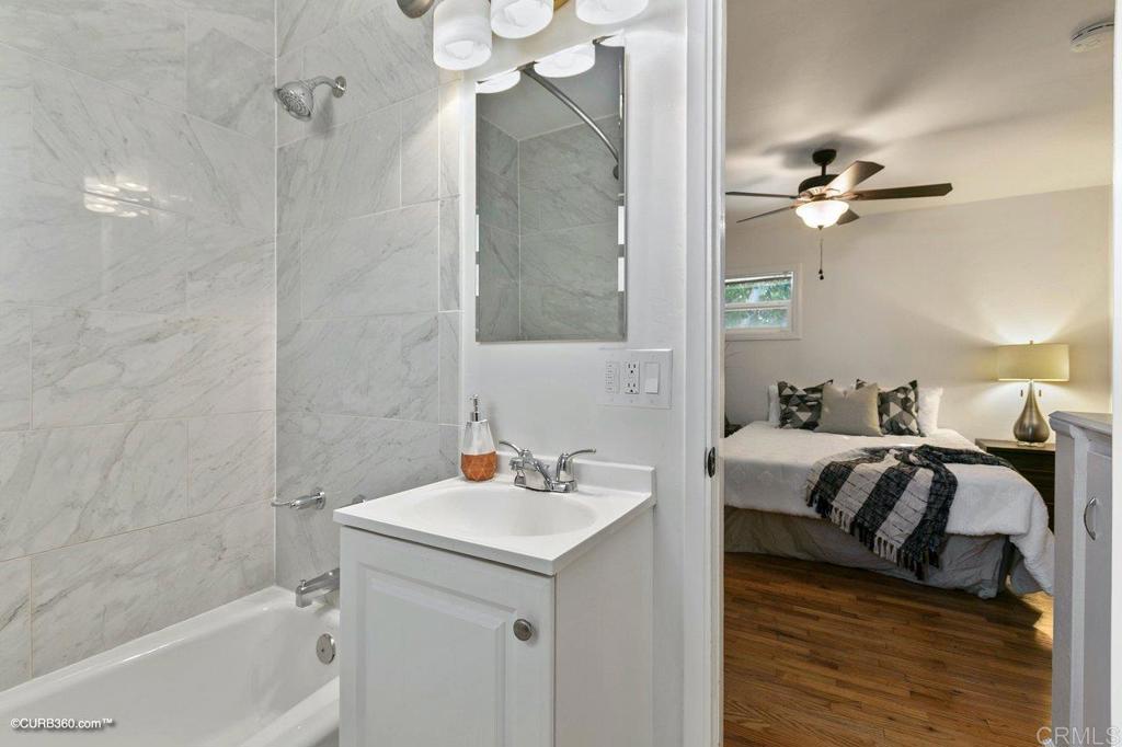 1453-1455 Thomas Avenue San Diego, CA 92109 - Photo 35 of 37 a bathroom with a sink a toilet and shower
