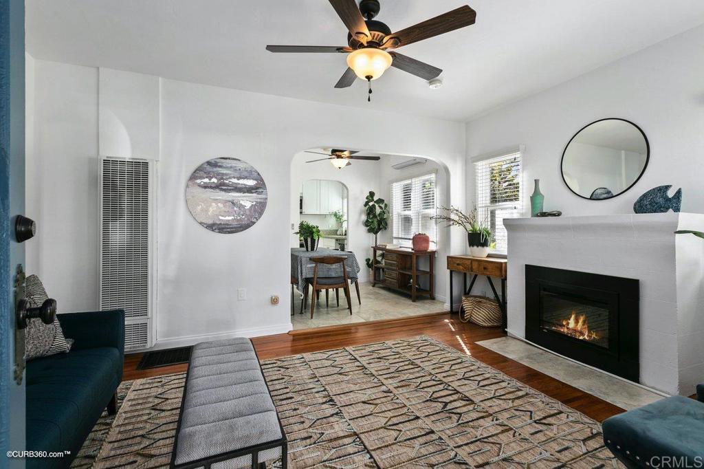 1453-1455 Thomas Avenue San Diego, CA 92109 - Photo 7 of 37 a living room with furniture a clock and a fireplace