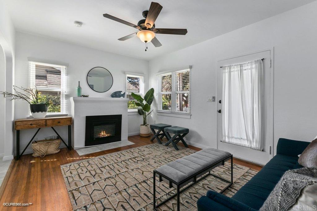 1453-1455 Thomas Avenue San Diego, CA 92109 - Photo 8 of 37 a living room with furniture a fireplace with wooden floor