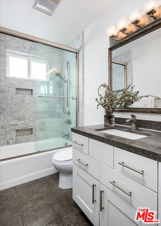 10944 Stever Street Culver City, CA 90230 - Photo 11 of 25 a bathroom with a granite countertop sink a toilet a mirror and bathtub