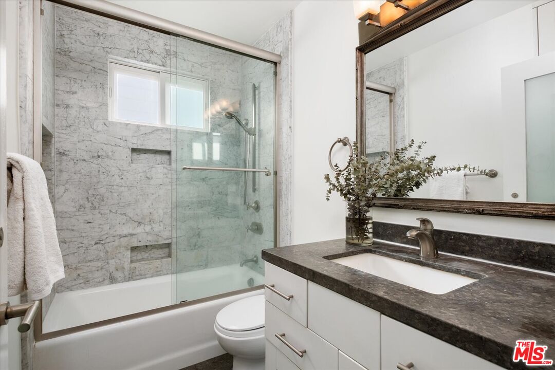 10944 Stever Street Culver City, CA 90230 - Photo 12 of 25 a bathroom with a granite countertop sink a toilet and shower