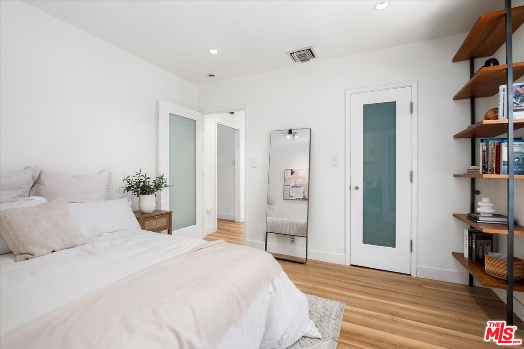 10944 Stever Street Culver City, CA 90230 - Photo 16 of 25 a bedroom with a bed and a book shelf