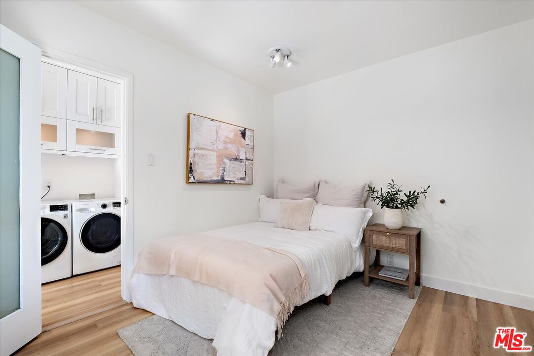 10944 Stever Street Culver City, CA 90230 - Photo 17 of 25 a bedroom with a bed a wall painting and a lamp