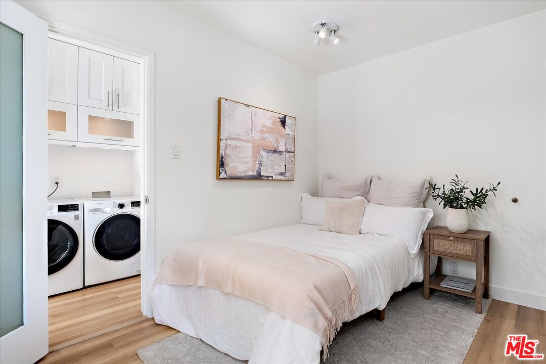 10944 Stever Street Culver City, CA 90230 - Photo 18 of 25 a bedroom with a bed and a chandelier