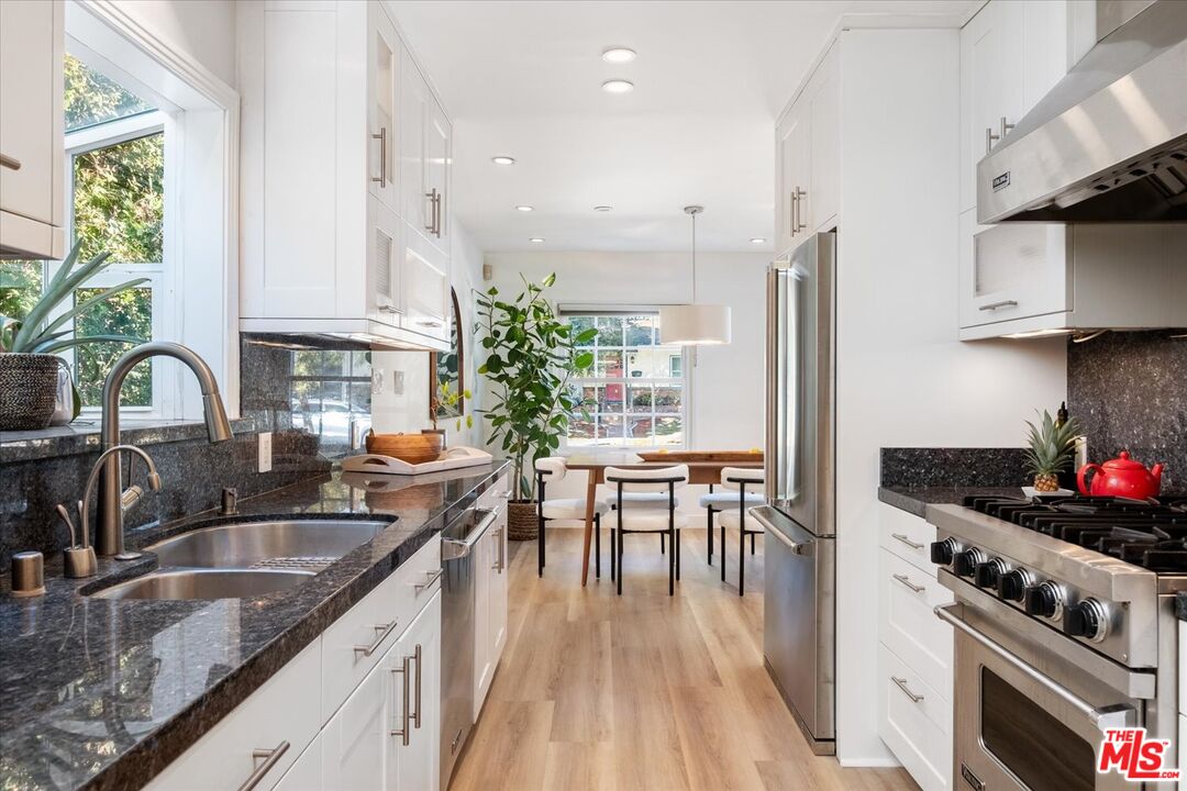 10944 Stever Street Culver City, CA 90230 - Photo 10 of 25 a kitchen with stainless steel appliances a sink a stove and a wooden floors