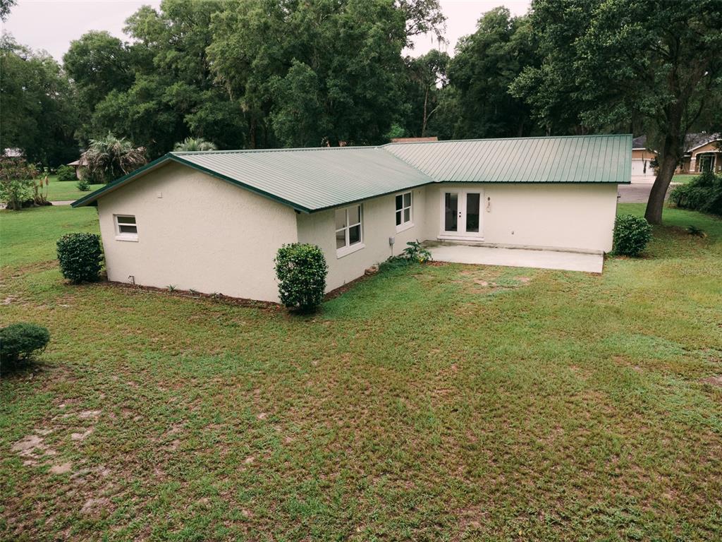 14522 Southeast 1st Av Road Summerfield, FL 34491 - Photo 27 of 30 a house that has a big yard with large trees