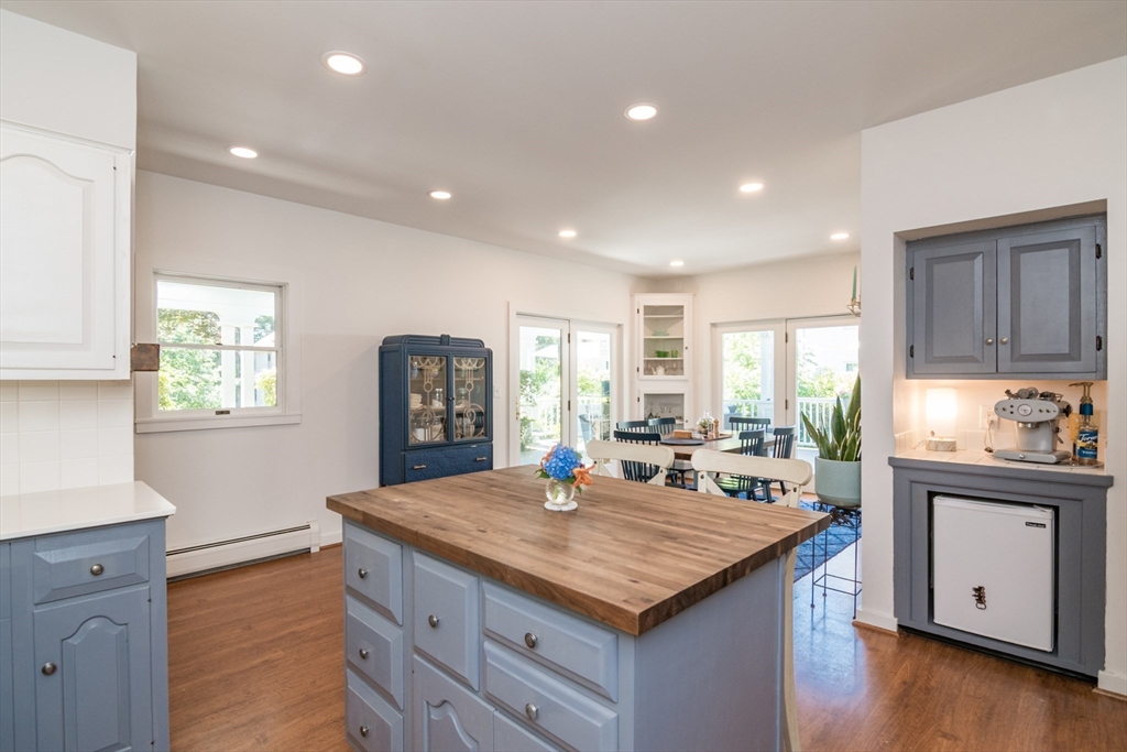 116 High Street Amherst, MA 01002 - Photo 13 of 42 a kitchen with kitchen island granite countertop wooden floors and a sink