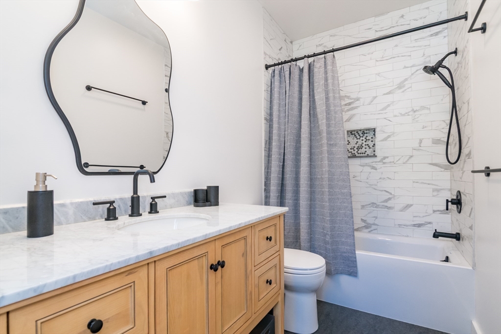 116 High Street Amherst, MA 01002 - Photo 27 of 42 a bathroom with a granite countertop sink toilet and shower