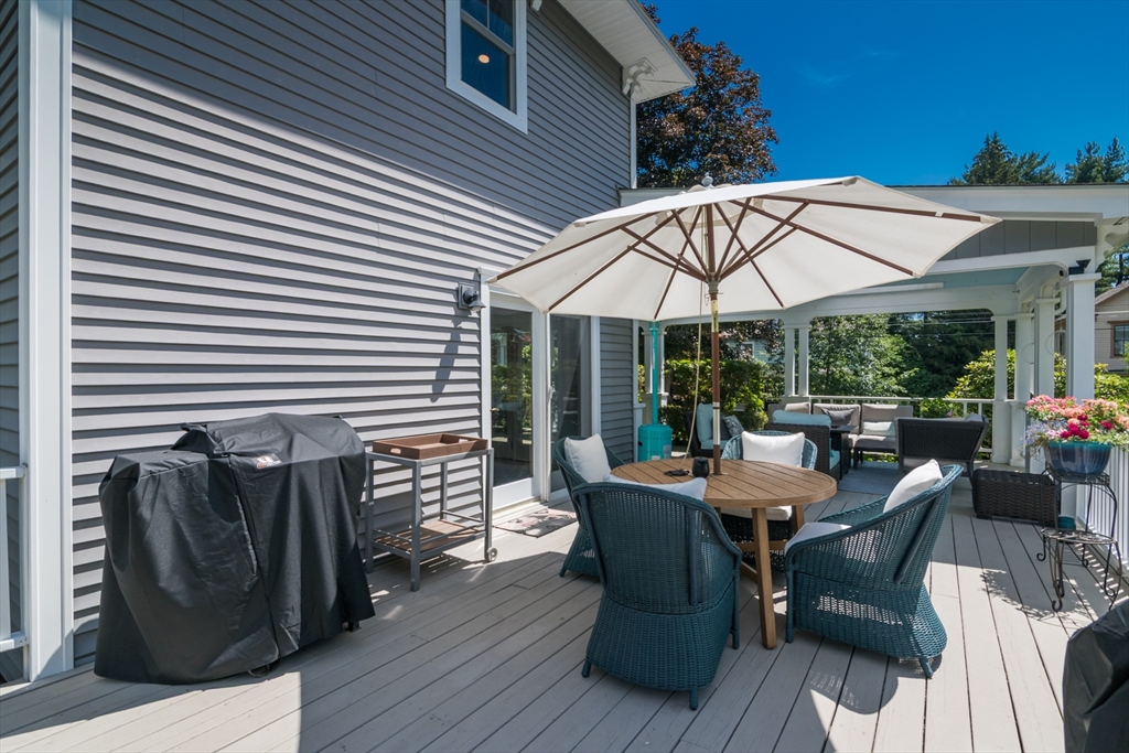 116 High Street Amherst, MA 01002 - Photo 38 of 42 a view of a patio with table and chairs under an umbrella