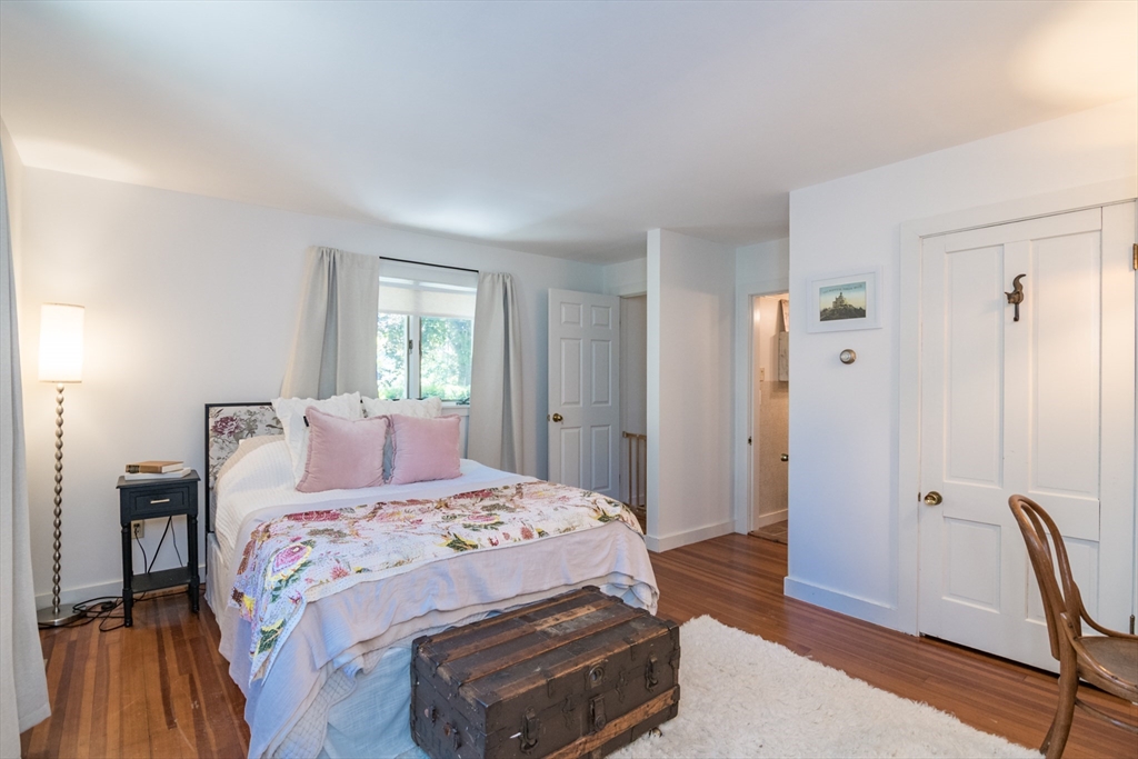 116 High Street Amherst, MA 01002 - Photo 5 of 42 a bedroom with a bed and a chair