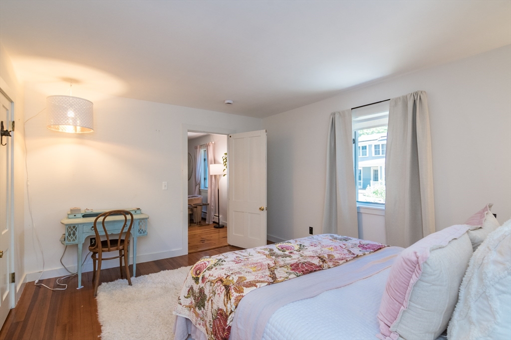 116 High Street Amherst, MA 01002 - Photo 6 of 42 a bedroom with a bed and a table in it