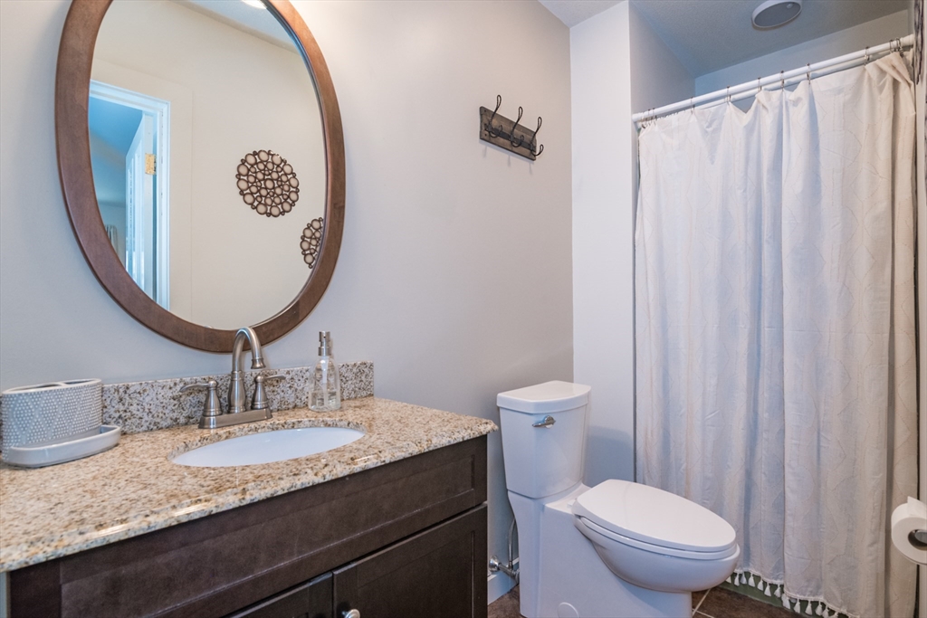116 High Street Amherst, MA 01002 - Photo 7 of 42 a bathroom with a granite countertop sink and a mirror