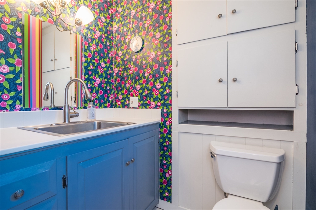 116 High Street Amherst, MA 01002 - Photo 8 of 42 a bathroom with a sink a toilet and a mirror