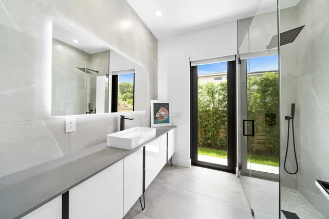 a living room with furniture and a view of kitchen