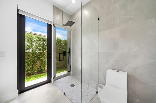 a living room with furniture kitchen view and a table