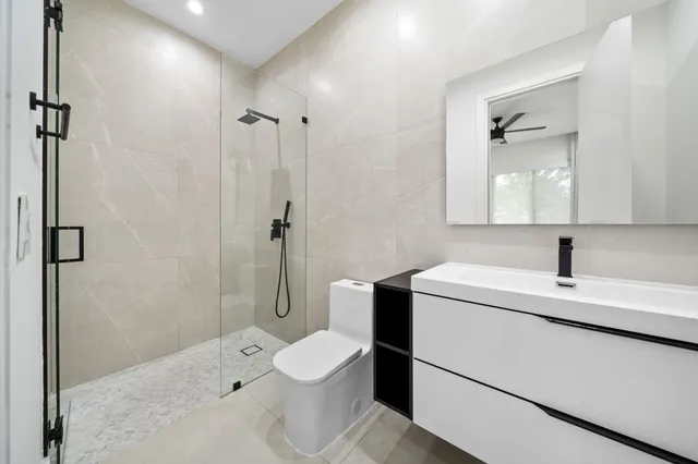 a living room with furniture a large window and wooden floor