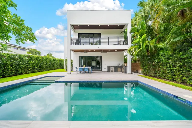 a living room with furniture and wall paintings