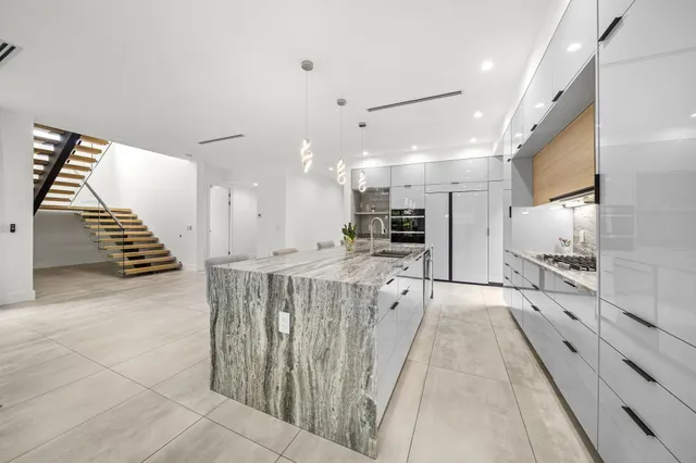 a spacious bedroom with a bed and a ceiling fan