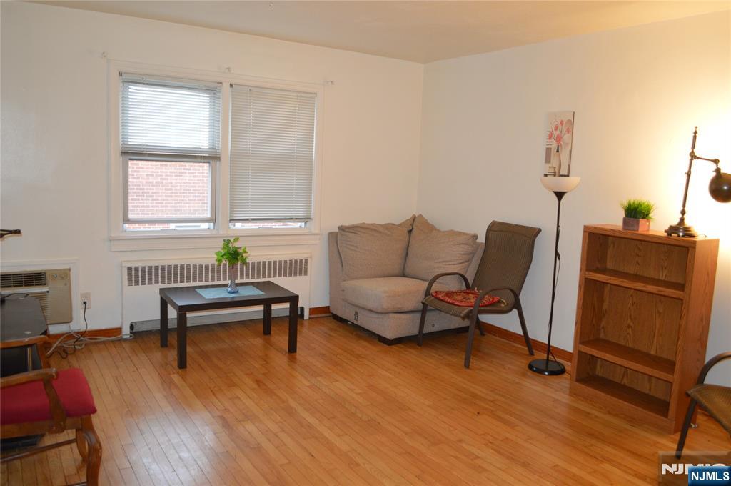 721 Broad Street, Unit 5A Newark, NJ 07102 - Photo 3 of 6 a living room with furniture and a wooden floor