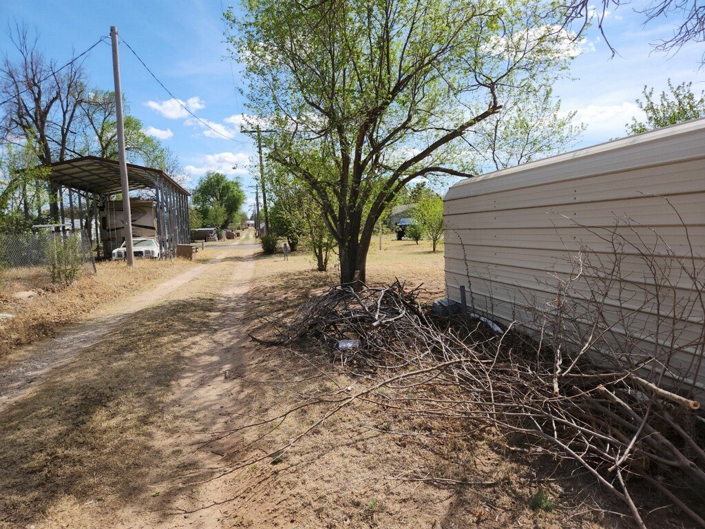 419 Fifth Street McLean, TX 79057 - Photo 8 of 34 a view of a backyard with a table and chairs under an umbrella