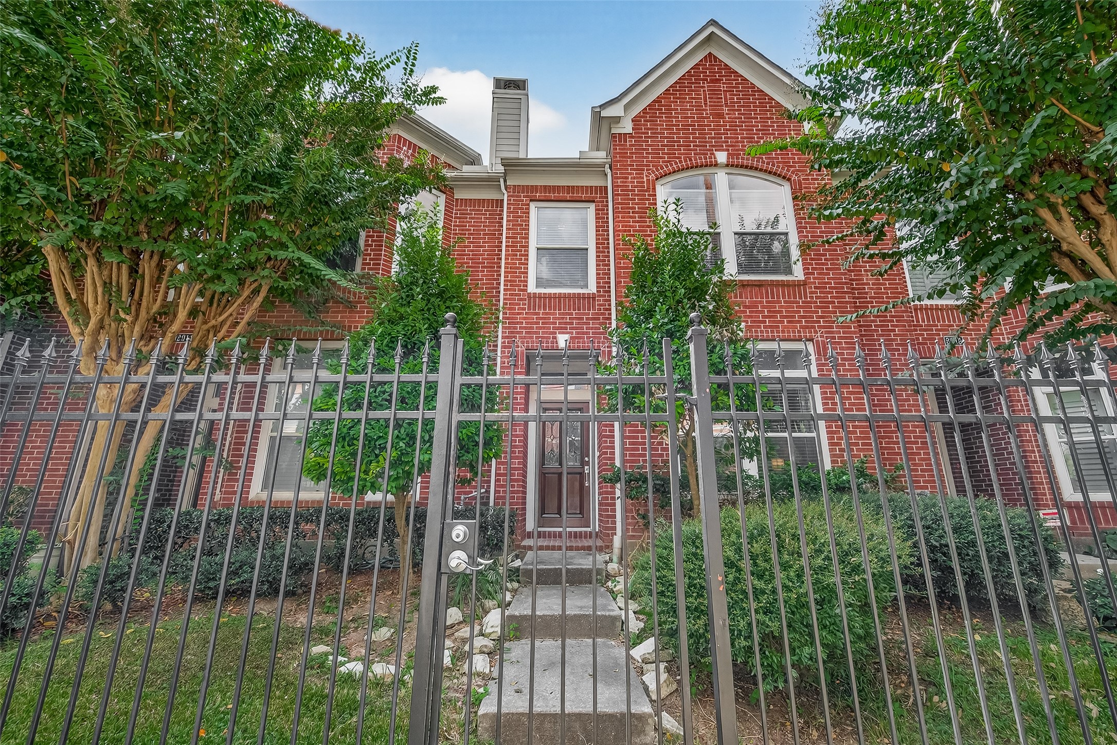 a front view of a house with a garden