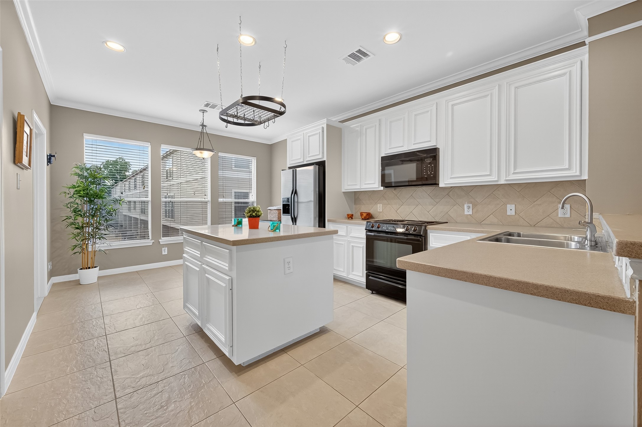2913 West Dallas Street Houston, TX 77019 - Photo 14 of 34 a kitchen with granite countertop a sink a stove and cabinets