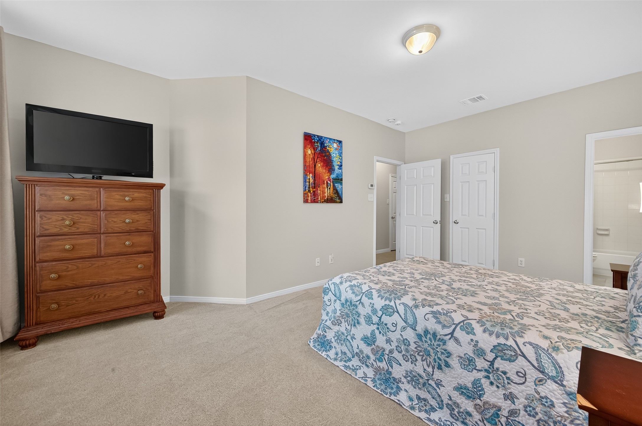 2913 West Dallas Street Houston, TX 77019 - Photo 19 of 34 a bedroom with a bed and a flat screen tv