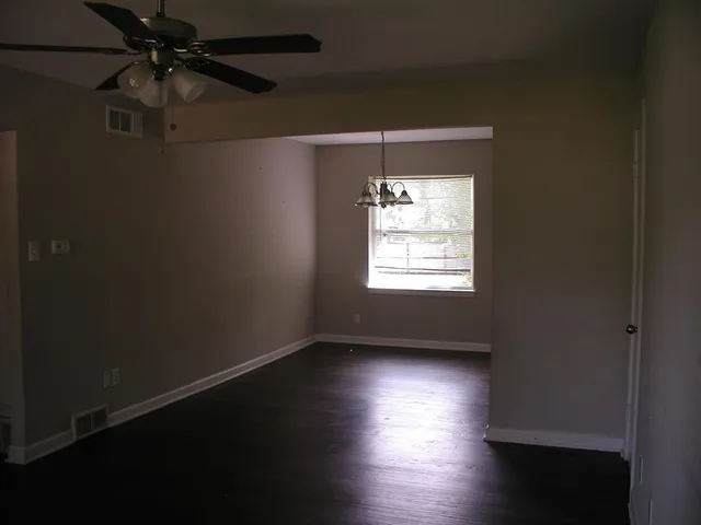 a view of room with window and hardwood floor