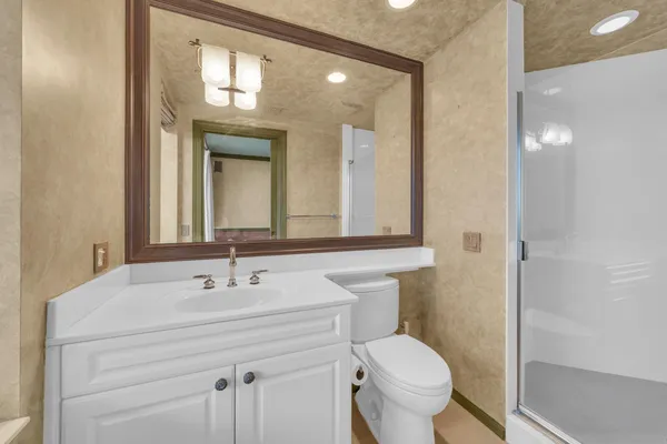 a bathroom with a sink toilet and a mirror