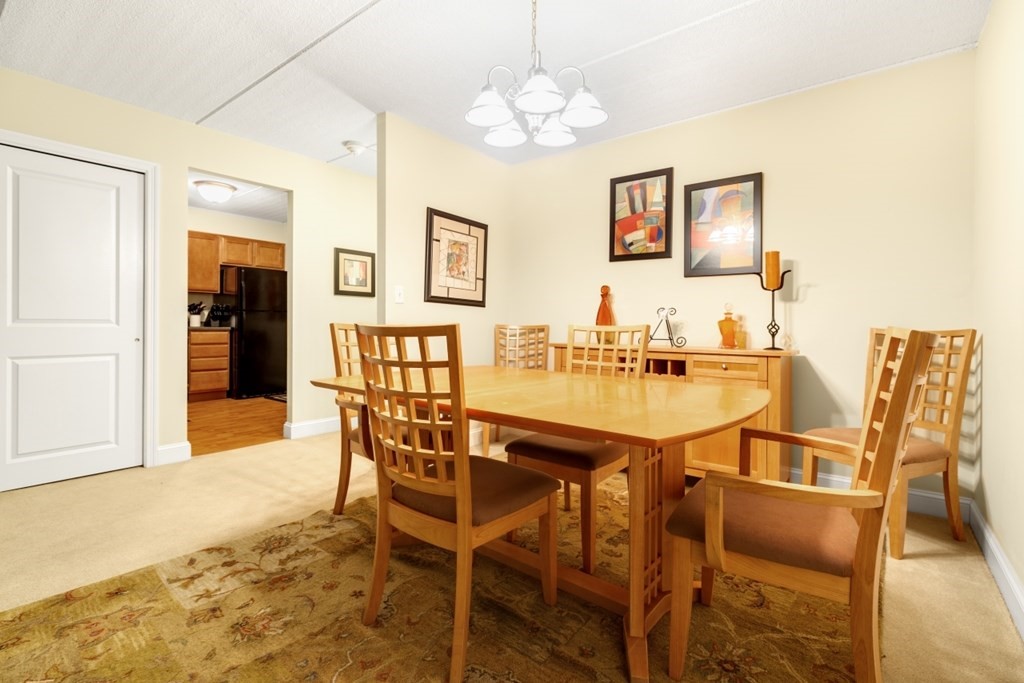 1500 Worcester Road, Unit 321 Framingham, MA 01702 - Photo 13 of 42 a dining room with furniture and window
