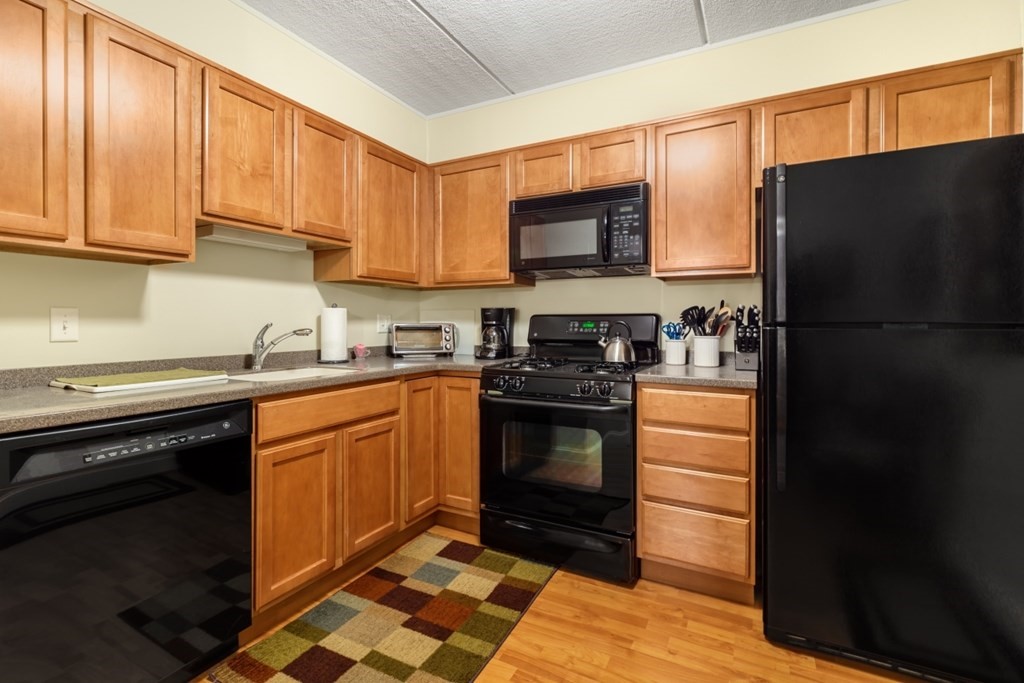 1500 Worcester Road, Unit 321 Framingham, MA 01702 - Photo 18 of 42 a kitchen with stainless steel appliances granite countertop a refrigerator stove top oven and sink