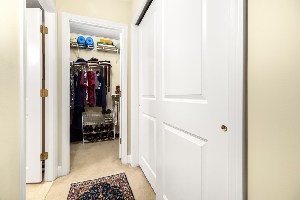 1500 Worcester Road, Unit 321 Framingham, MA 01702 - Photo 24 of 42 a view of walk in closet with clothes and shoes