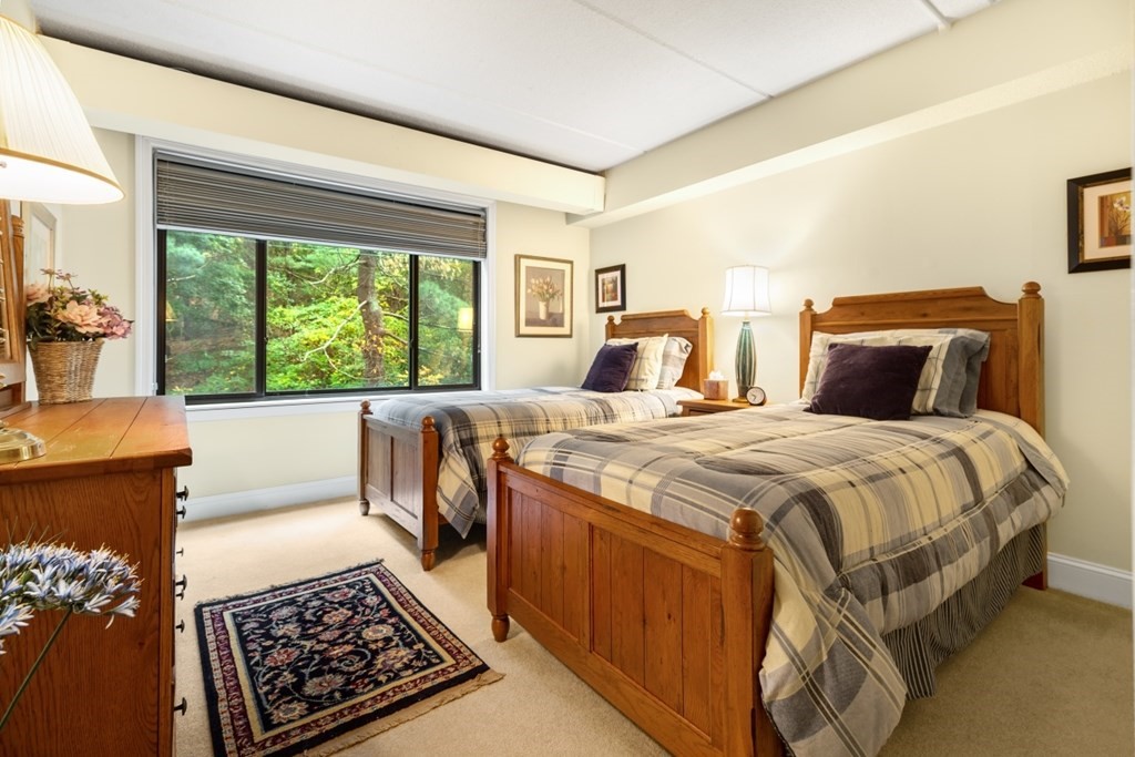 1500 Worcester Road, Unit 321 Framingham, MA 01702 - Photo 31 of 42 a bed sitting in a bedroom next to a window