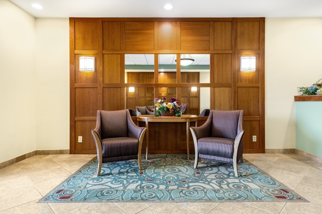 1500 Worcester Road, Unit 321 Framingham, MA 01702 - Photo 4 of 42 a living room with furniture and a potted plant