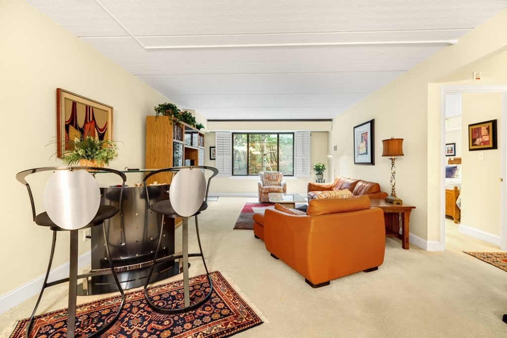 1500 Worcester Road, Unit 321 Framingham, MA 01702 - Photo 10 of 42 a living room with furniture a couch and a table