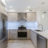a kitchen with refrigerator sink and stove