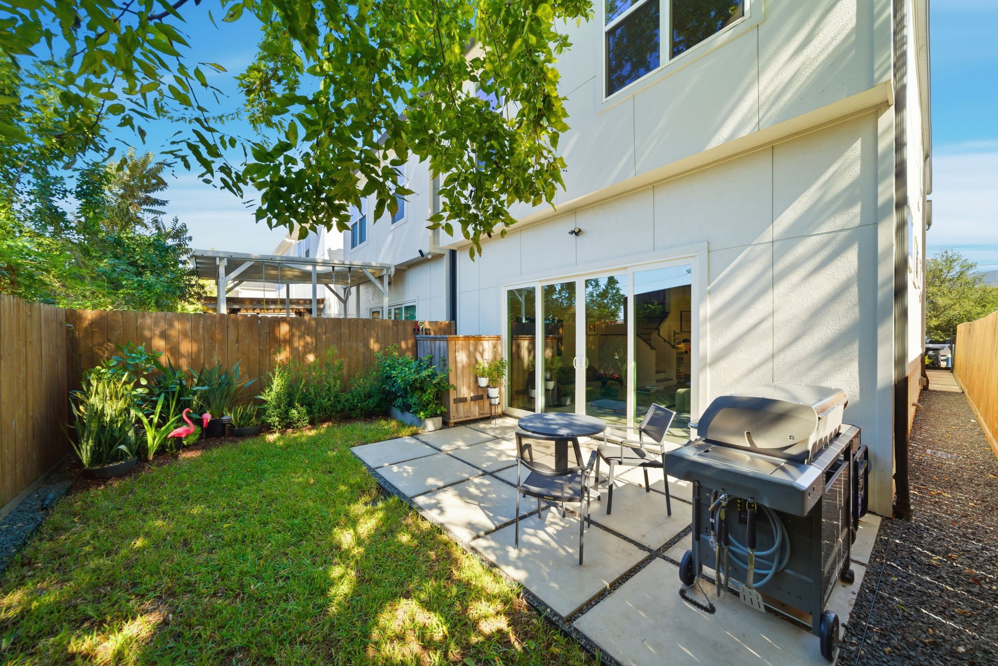 1529 Laird Street Houston, TX 77008 - Photo 31 of 31 a view of a patio with table and chairs and potted plants with wooden fence