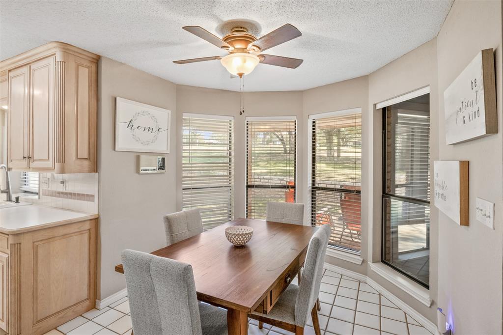 8919 Bontura Road Granbury, TX 76049 - Photo 12 of 35 a view of a dining room with furniture and a chandelier