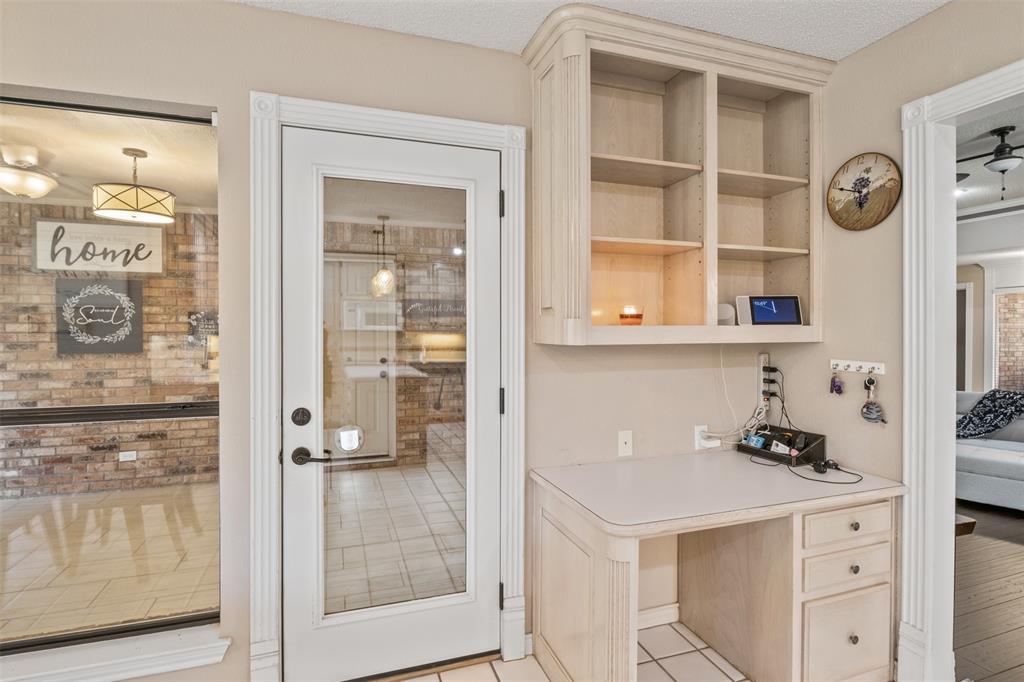 8919 Bontura Road Granbury, TX 76049 - Photo 16 of 35 a kitchen with a refrigerator and cabinets