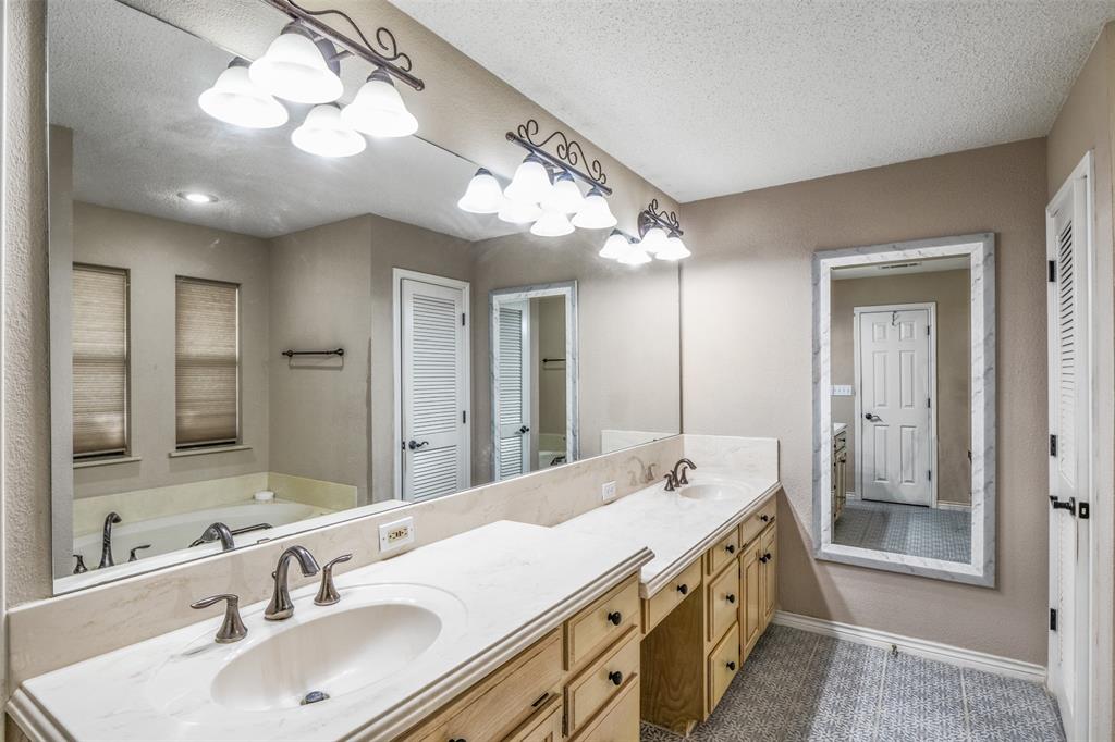 8919 Bontura Road Granbury, TX 76049 - Photo 19 of 35 a bathroom with a double vanity sink and a mirror