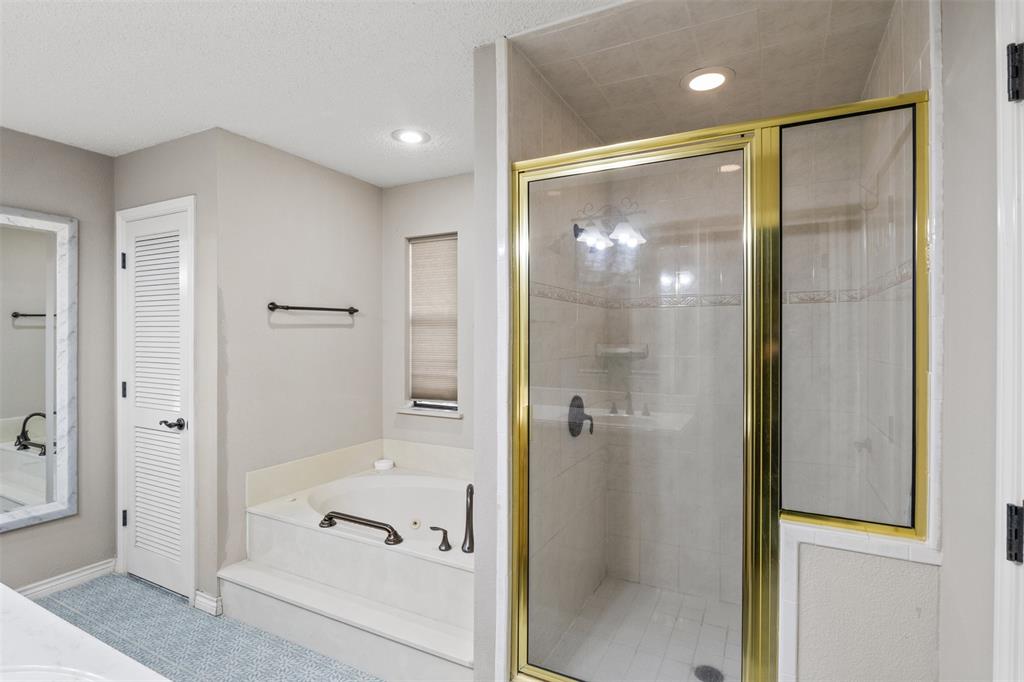8919 Bontura Road Granbury, TX 76049 - Photo 20 of 35 a bathroom with a glass shower door