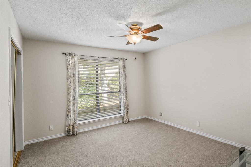 8919 Bontura Road Granbury, TX 76049 - Photo 23 of 35 an empty room with windows and fan