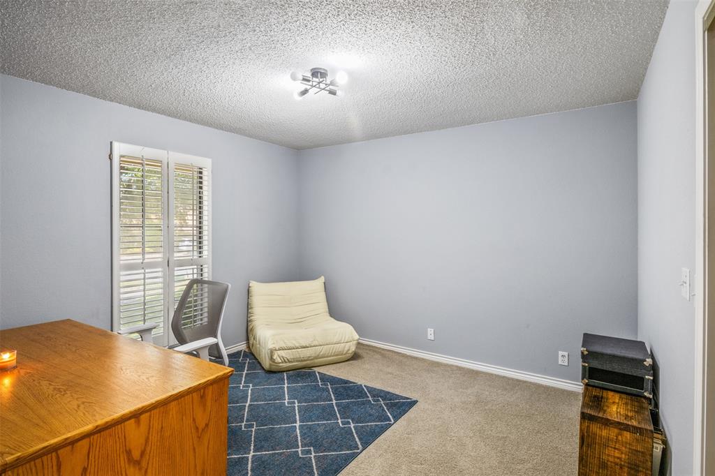 8919 Bontura Road Granbury, TX 76049 - Photo 24 of 35 a bedroom with a bed and a window