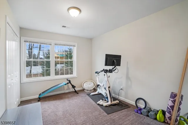 a room with gym equipment and a window