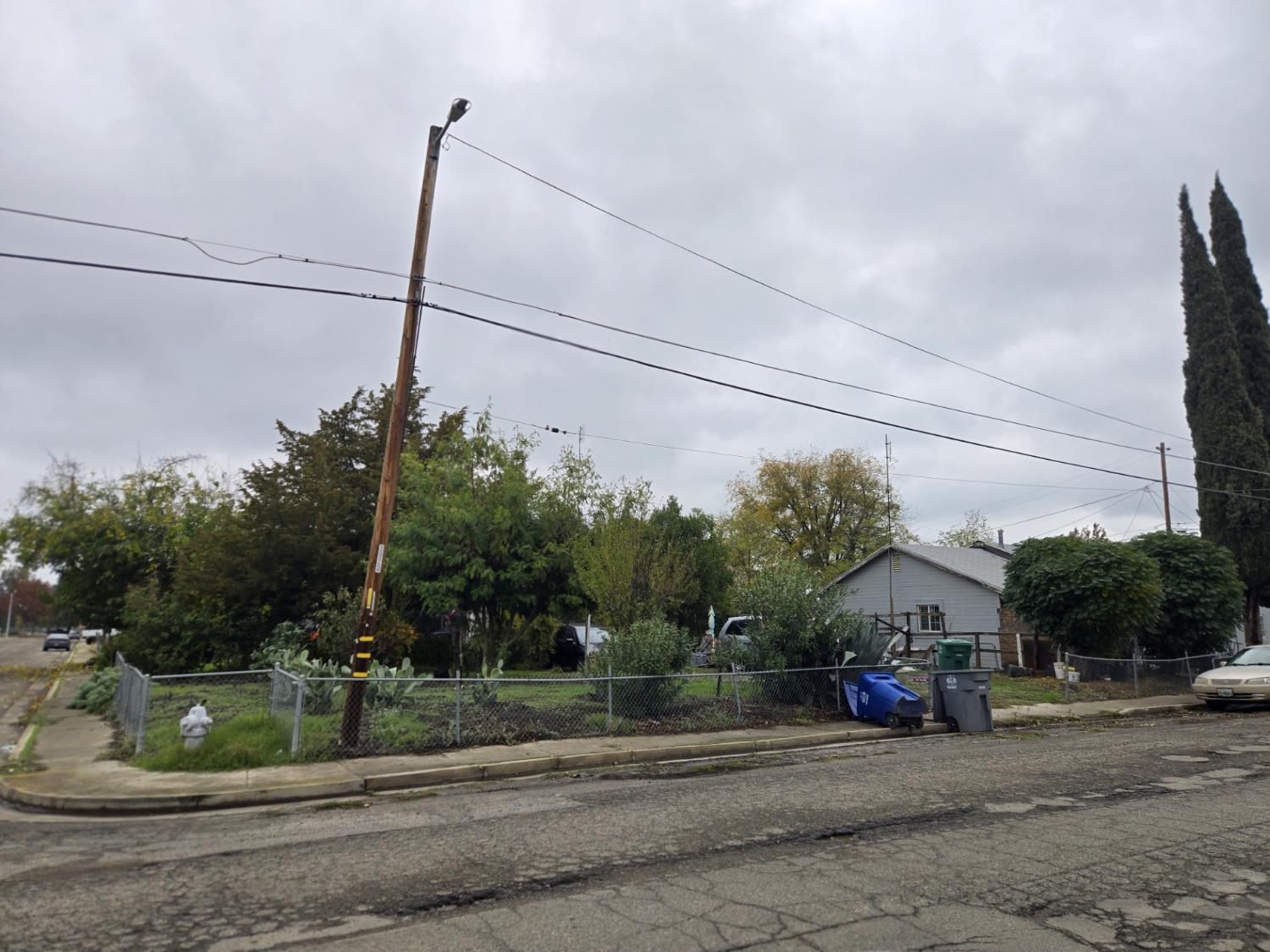 1726 Merced Street Dos Palos, CA 93620 - Photo 2 of 12 a view of a road with a cars parked on the road