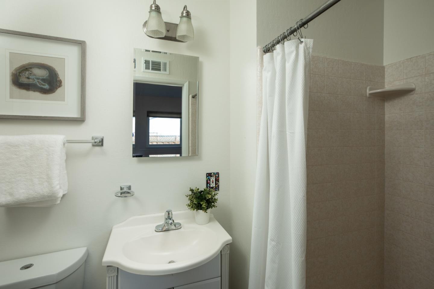2545 Austin Place Santa Clara, CA 95050 - Photo 15 of 21 a bathroom with a sink a mirror and a toilet