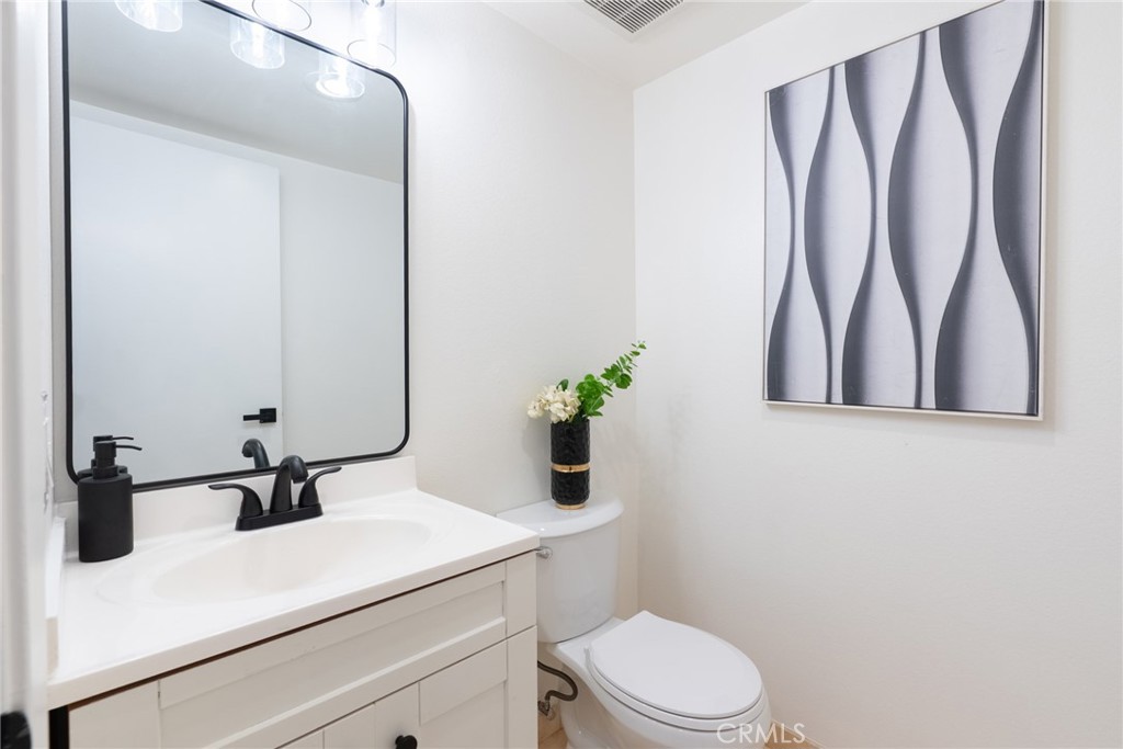 1024 West Lamark Lane Anaheim, CA 92802 - Photo 12 of 34 a bathroom with a sink a toilet and a mirror